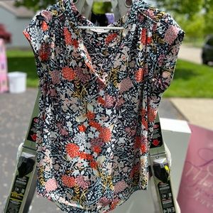 Dressy/casual women’s blouse, multicolor flowers, navy background.